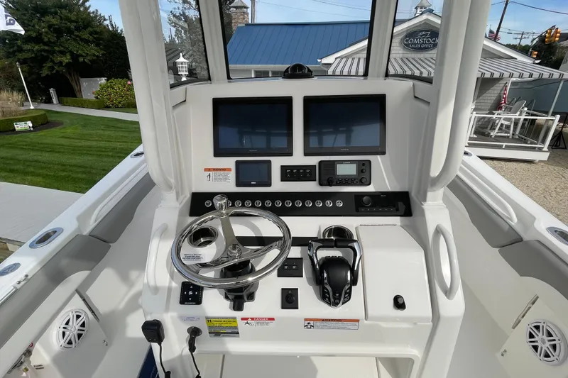Slide: The Image of 2026 Regulator 25 boat helm with dual screens and modern controls. - 12