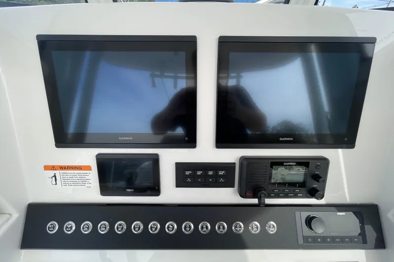 Slide: The Image of Control panel of 2026 Regulator 25 boat with Garmin displays and Yamaha controls. - 13