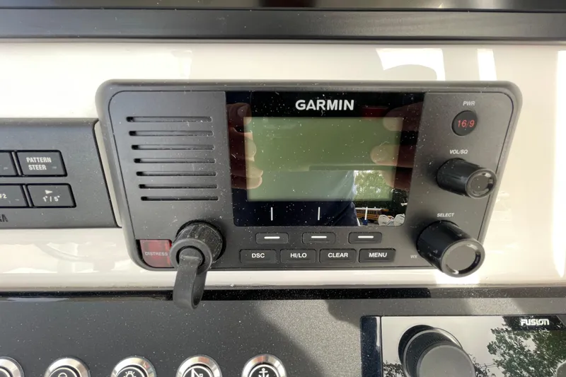 Slide: The Image of Garmin marine radio on 2026 Regulator 25 boat dashboard with control knobs. - 16