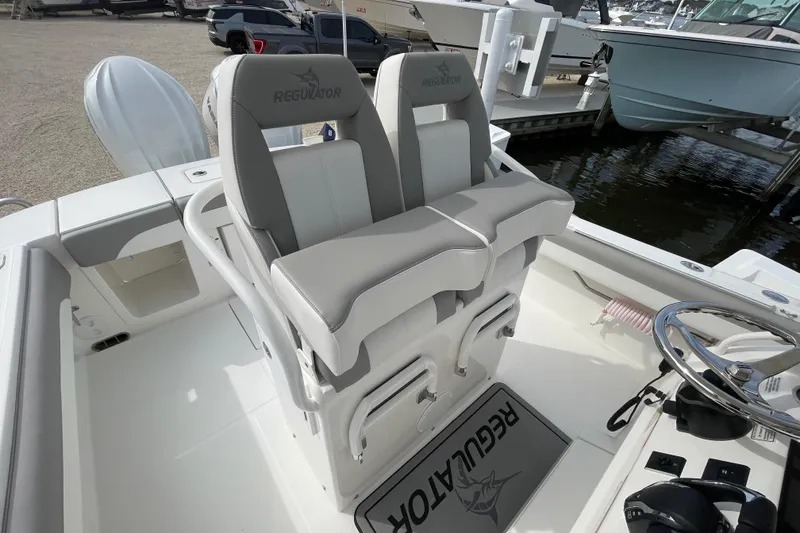 Slide: The Image of 2026 Regulator 25 boat interior with dual seats and steering wheel. - 19