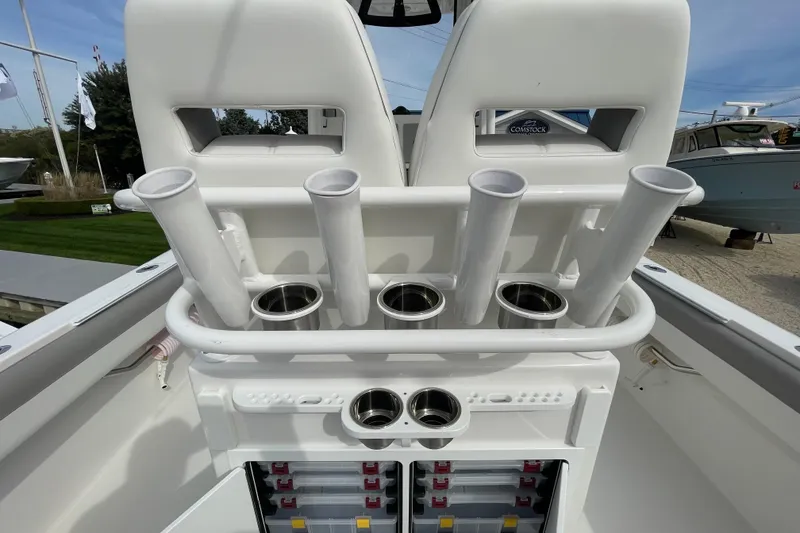 Slide: The Image of 2026 Regulator 25 boat with rod holders and storage compartments. - 23
