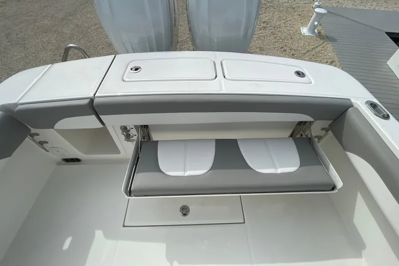 Slide: The Image of 2026 Regulator 25 boat with foldable seating and storage compartments. - 26