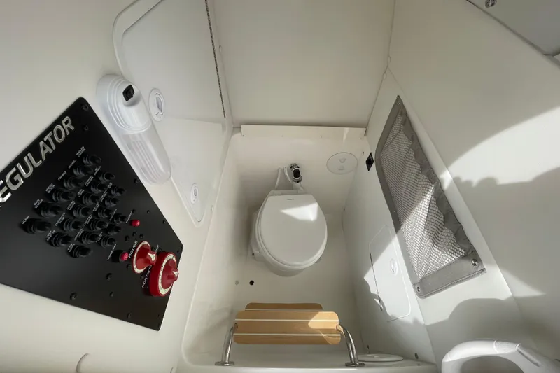 Slide: The Image of 2026 Regulator 25 boat interior with control panel and compact marine toilet. - 9