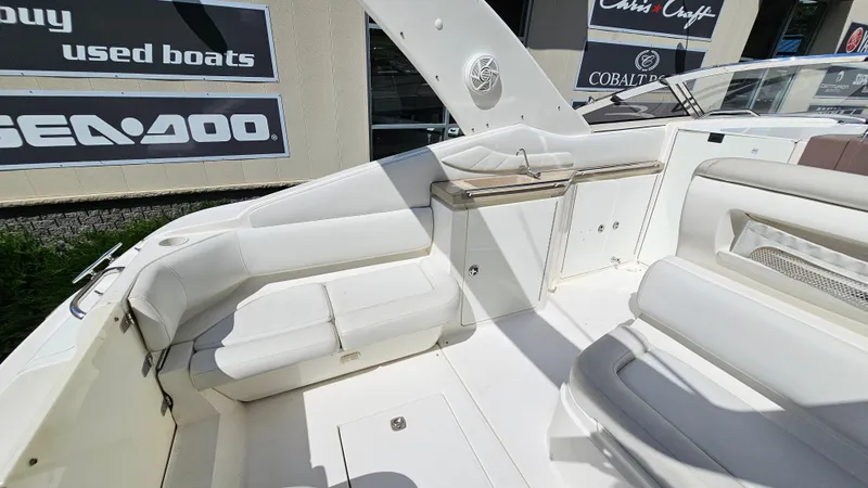Slide: The Image of 2003 Regal Commodore 3260 boat interior with white seating and storage compartments. - 10