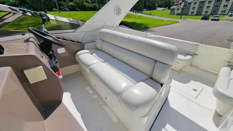 Slide: The Image of 2003 Regal Commodore 3260 boat interior with white seating and steering area. - 11