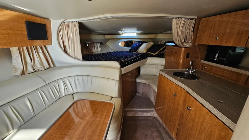 Slide: The Image of Interior of 2003 Regal Commodore 3260 yacht with seating, bed, and kitchenette. - 18