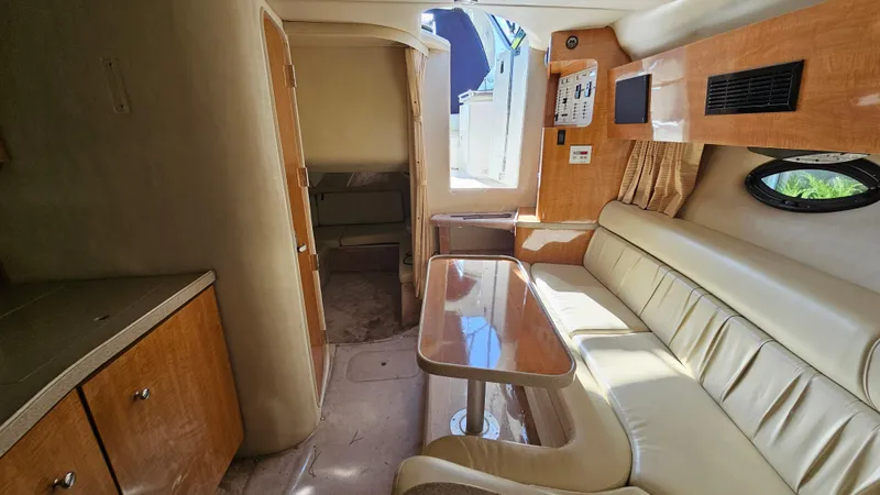 Slide: The Image of Interior of 2003 Regal Commodore 3260 yacht with seating and table. - 24