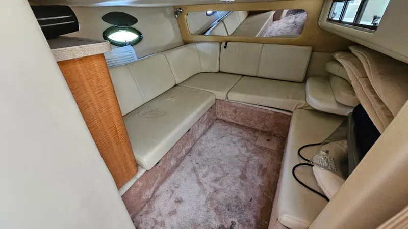 Slide: The Image of Interior of 2003 Regal Commodore 3260 boat with beige seating and carpet. - 26
