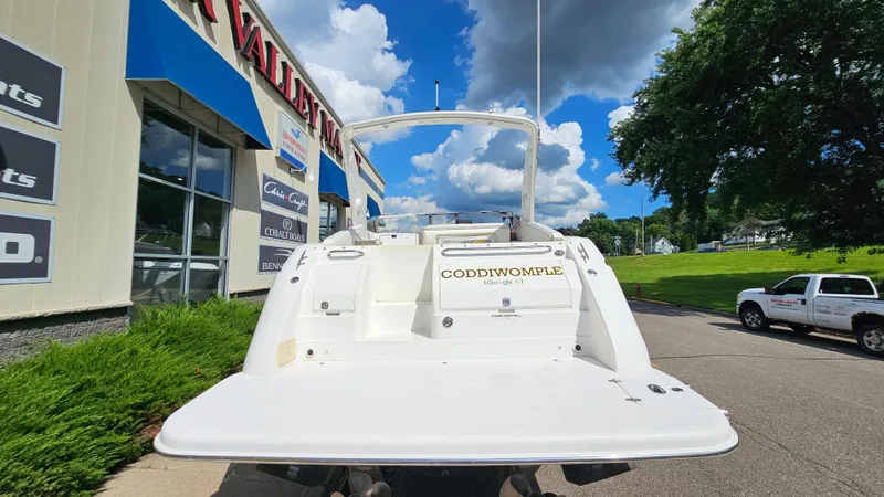 Slide: The Image of 2003 Regal Commodore 3260 boat at dealership, sunny day, blue sky, green landscape. - 5