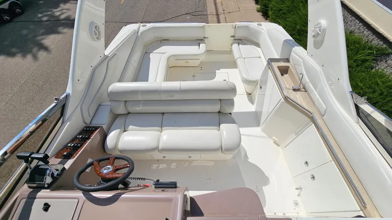 Slide: The Image of 2003 Regal Commodore 3260 boat interior with white seating and steering wheel. - 8