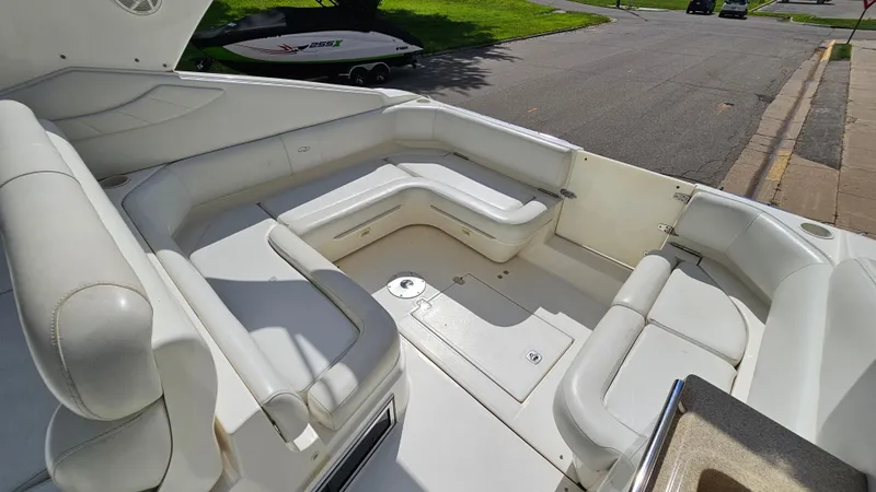 Slide: The Image of 2003 Regal Commodore 3260 boat interior with white seating and storage compartments. - 9
