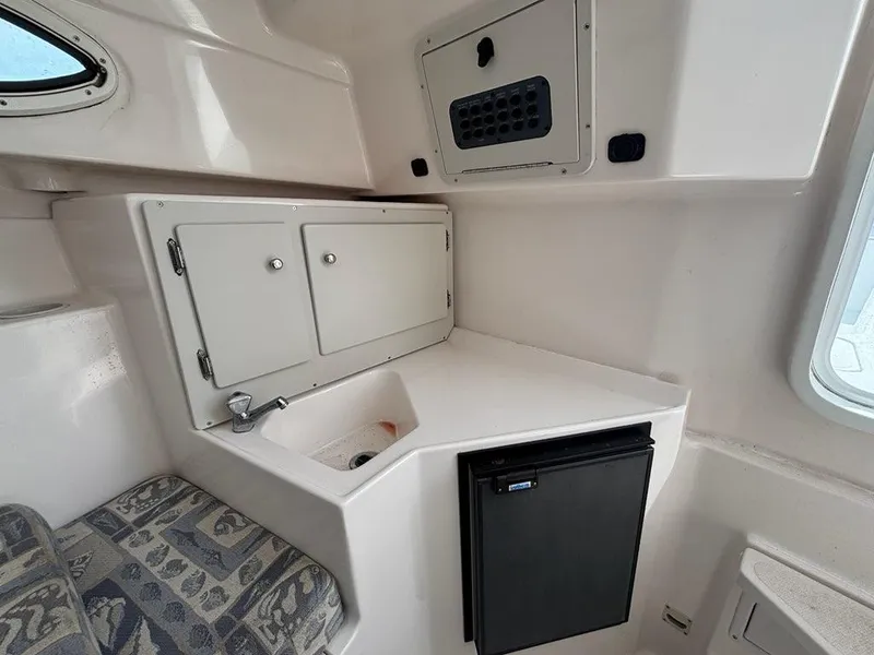 Slide: The Image of 2005 Polar 2300 Walkaround cabin interior with patterned cushions and porthole. - 14