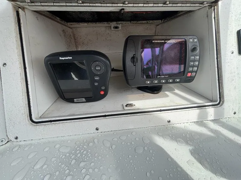 Slide: The Image of 2005 Polar 2300 Walkaround boat interior with seating and storage compartments. - 18