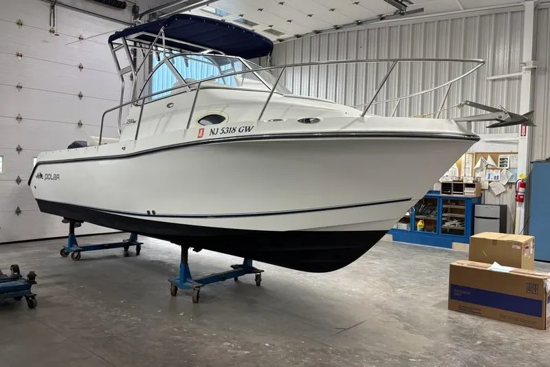 Slide: The Image of 2005 Polar 2300 Walkaround boat docked at marina, sunny day. - 3