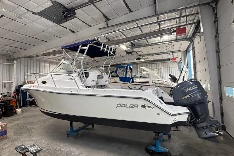 Slide: The Image of 2005 Polar 2300 Walkaround boat in a spacious indoor storage facility. - 4