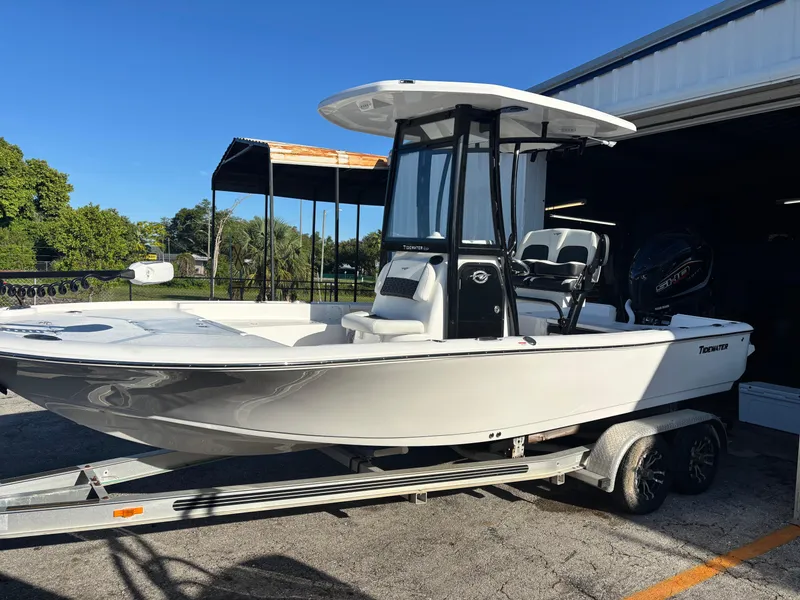 The Image of 2026 Tidewater 2210 Carolina Bay boat on trailer, parked outdoors under clear blue sky. - 0