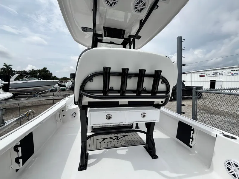 Slide: The Image of 2026 Tidewater 2210 Carolina Bay boat interior with rod holders and storage drawers. - 10