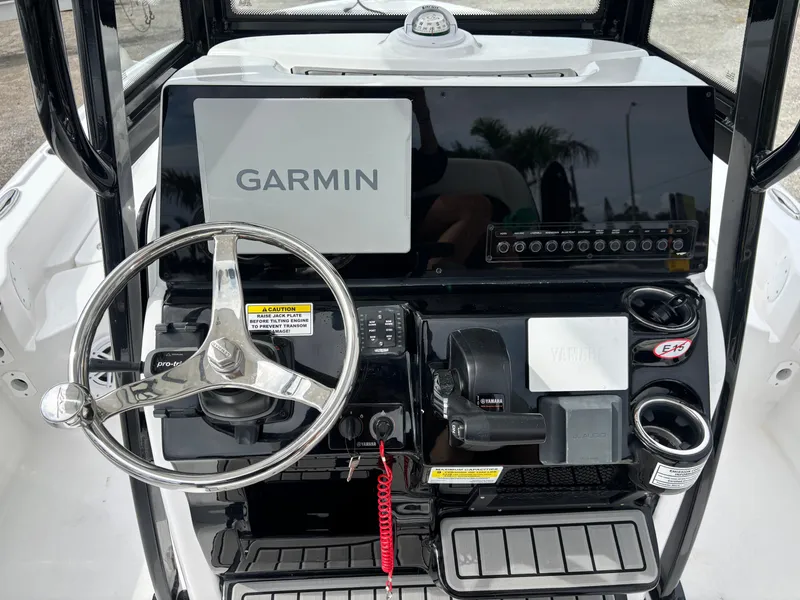 Slide: The Image of 2026 Tidewater 2210 Carolina Bay boat console with Garmin navigation system and steering wheel. - 13