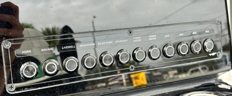 Slide: The Image of Control panel of 2026 Tidewater 2210 Carolina Bay boat with labeled buttons. - 14