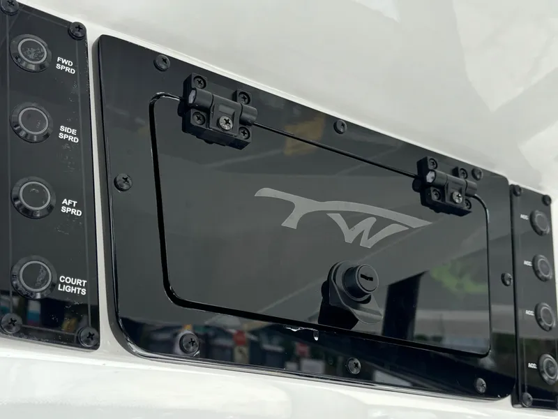 Slide: The Image of Control panel of 2026 Tidewater 2210 Carolina Bay boat with switches and logo. - 15