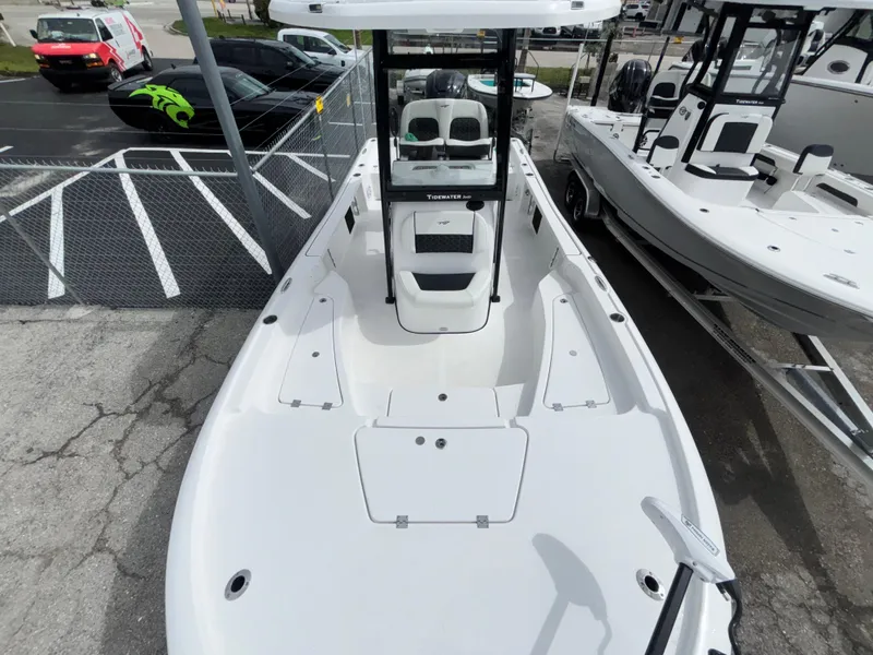 Slide: The Image of 2026 Tidewater 2210 Carolina Bay boat, white deck, parked in a marina. - 21