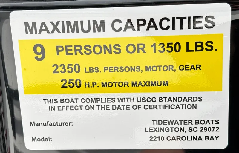 Slide: The Image of 2026 Tidewater 2210 Carolina Bay boat capacity label, 9 persons or 1350 lbs, 250 HP max. - 31