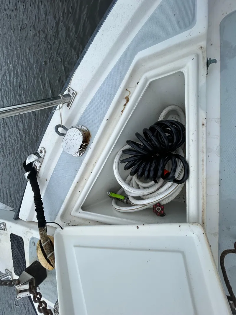 Slide: The Image of Deck storage on a 1998 Monk 36 boat with coiled hoses and anchor chain. - 10