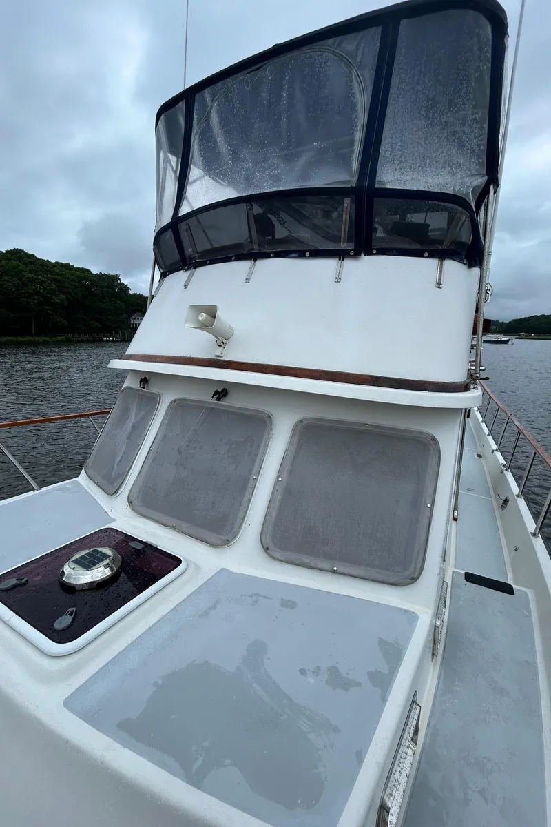 Slide: The Image of 1998 Monk 36 boat with enclosed flybridge on a calm river. - 13