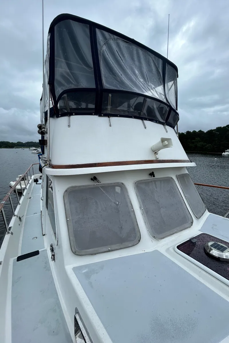 Slide: The Image of 1998 Monk 36 boat with enclosed flybridge on a cloudy day. - 14