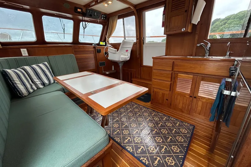 Slide: The Image of Cozy interior of 1998 Monk 36 boat with wooden cabinetry and seating area. - 2