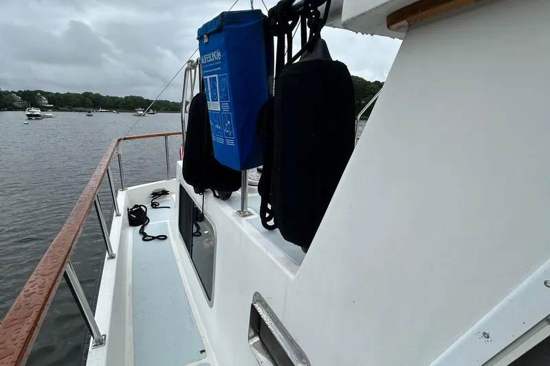 Slide: The Image of Side view of a 1998 Monk 36 boat on a calm river. - 20