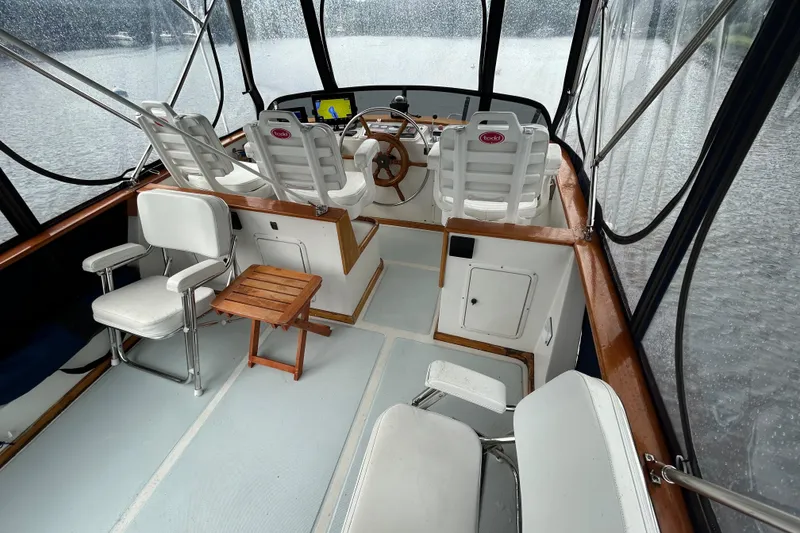 Slide: The Image of Interior of a 1998 Monk 36 boat with seating and steering wheel. - 25