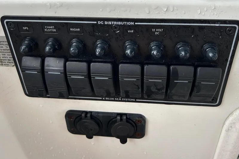 Slide: The Image of Control panel of a 1998 Monk 36 boat with switches for GPS, radar, and more. - 29