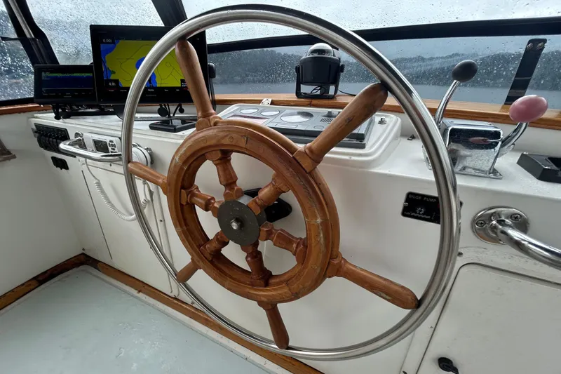 Slide: The Image of Steering wheel of a 1998 Monk 36 boat with navigation equipment and controls. - 31