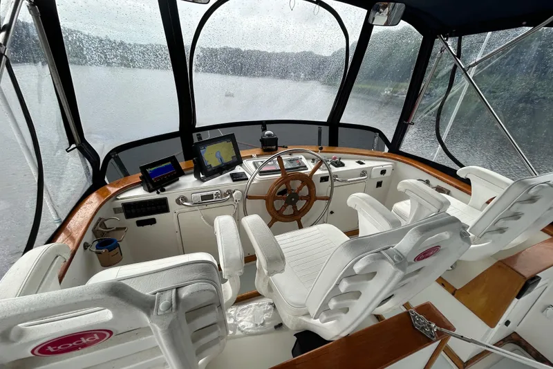 Slide: The Image of Interior of a 1998 Monk 36 boat with steering wheel and navigation equipment. - 32