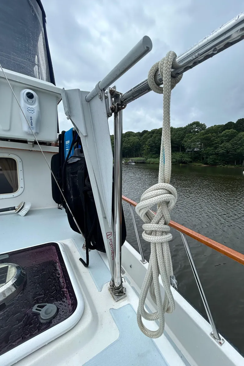 Slide: The Image of Sailboat deck with coiled rope, Monk 36 model, 1998, near a calm river. - 37