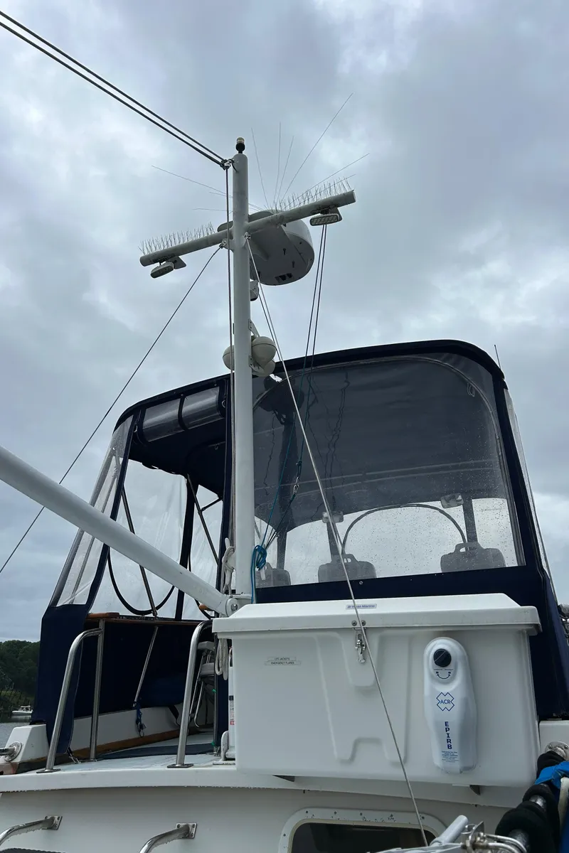 Slide: The Image of 1998 Monk 36 boat with radar and navigation equipment under cloudy sky. - 38