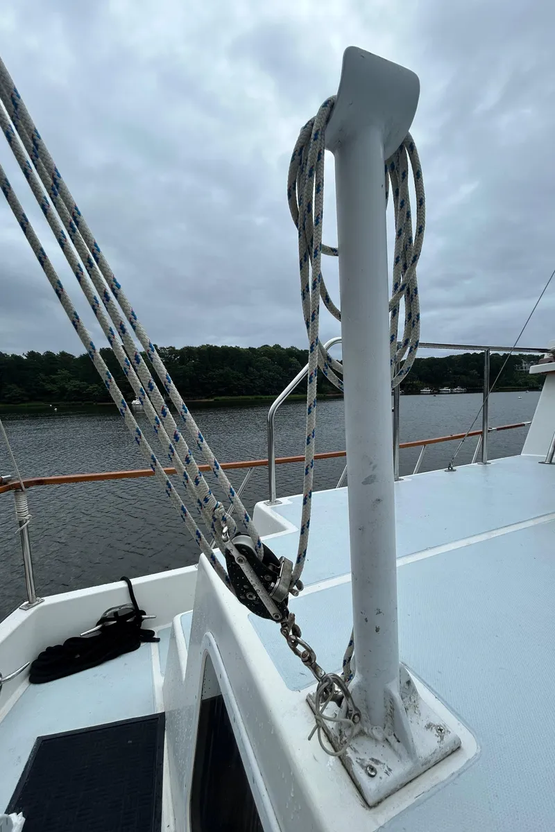 Slide: The Image of Sailboat deck with ropes and railing, Monk 36 model, 1998, on a cloudy day. - 39