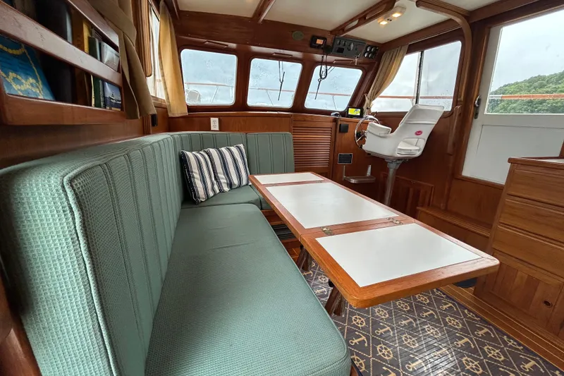 Slide: The Image of Cozy interior of a 1998 Monk 36 boat with seating and navigation area. - 40