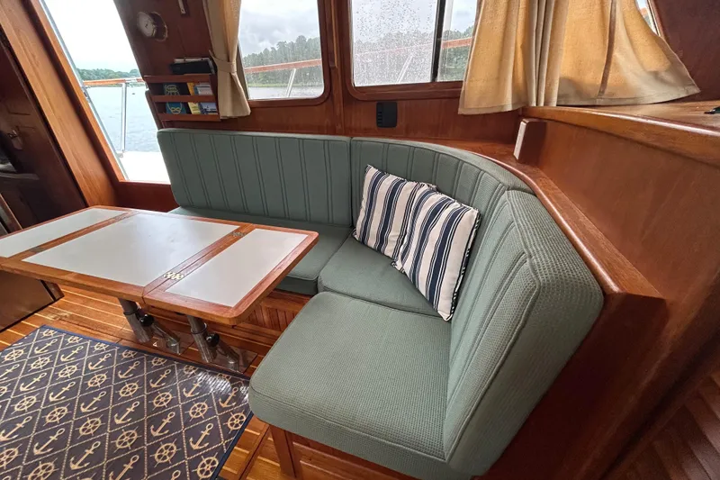 Slide: The Image of Cozy interior of 1998 Monk 36 boat with cushioned seating and nautical decor. - 43