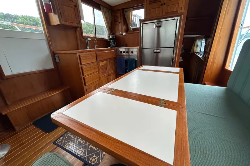 Slide: The Image of Interior of a 1998 Monk 36 boat with wooden cabinetry and dining area. - 45