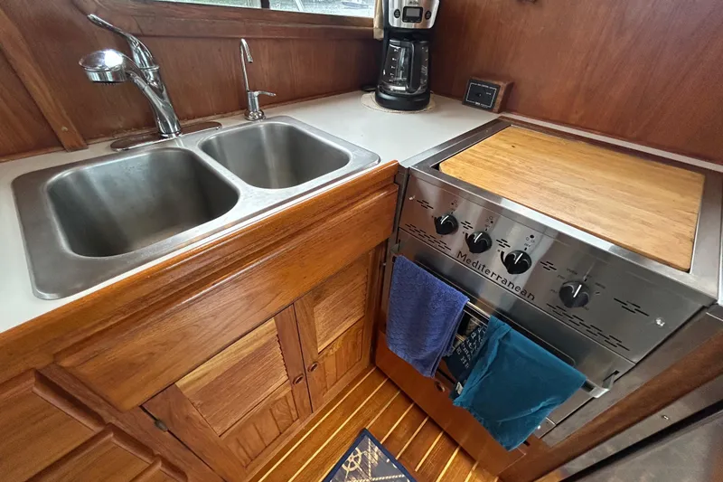 Slide: The Image of Wooden boat kitchen with double sink, stove, and coffee maker, Monk 36, 1998 model. - 46