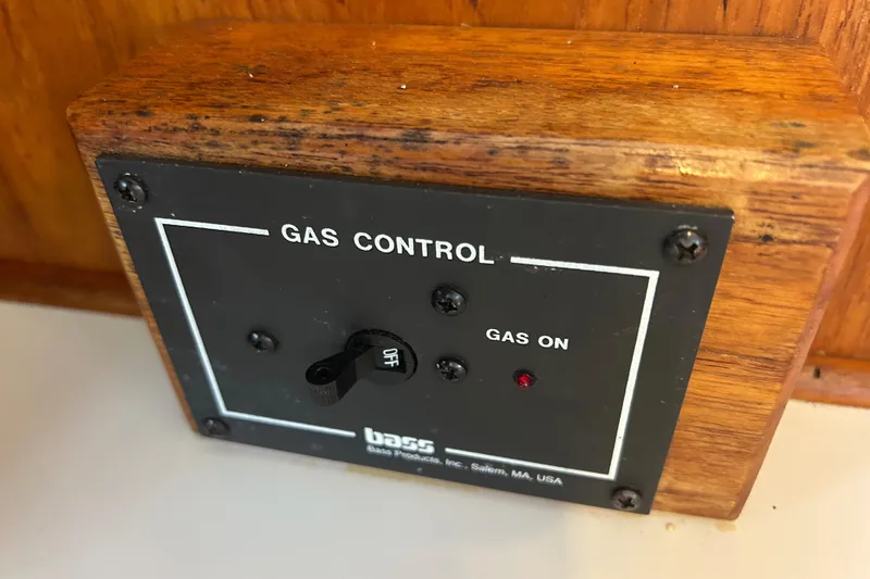 Slide: The Image of Gas control panel with on/off switch, wooden frame, and red indicator light. - 49