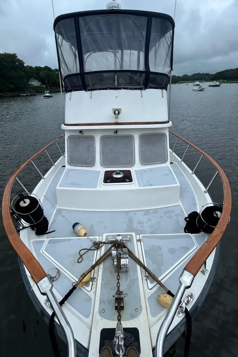 Slide: The Image of Bow view of a 1998 Monk 36 boat on a calm river. - 8