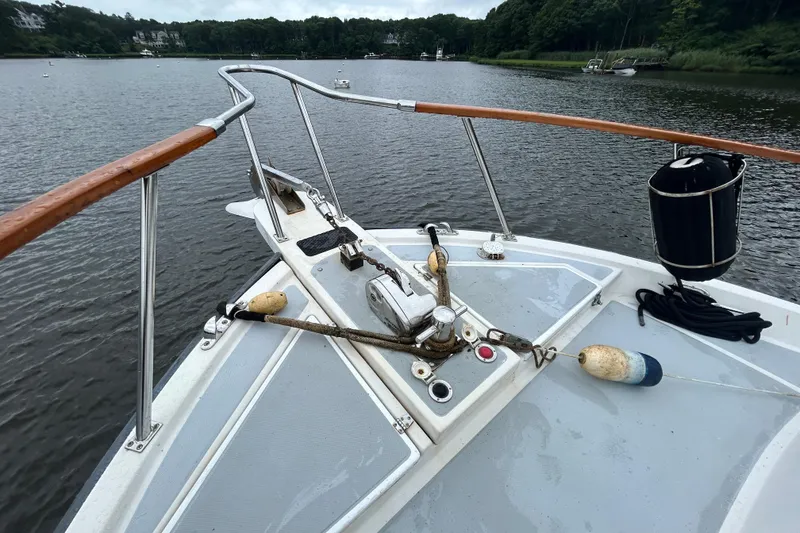 Slide: The Image of Bow of 1998 Monk 36 boat with anchor and buoys on calm water. - 9