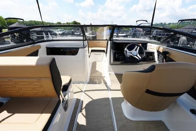 Slide: The Image of Interior of 2025 Sea Ray SPX 190 boat with beige seating and modern dashboard. - 10