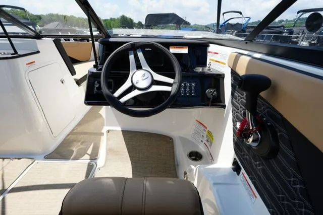 Slide: The Image of 2025 Sea Ray SPX 190 boat cockpit with steering wheel and control panel. - 12