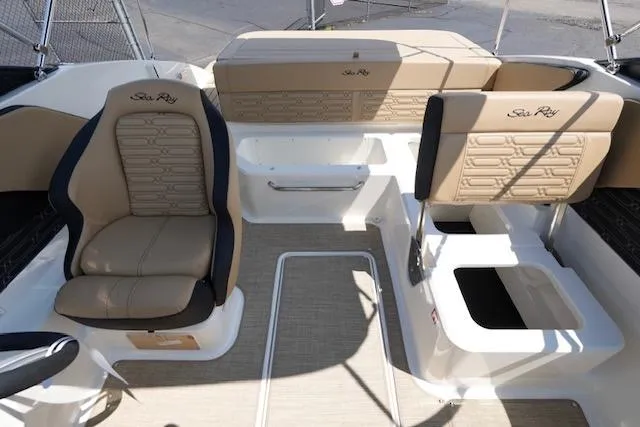 Slide: The Image of 2025 Sea Ray SPX 190 boat interior with beige seating and modern design. - 14