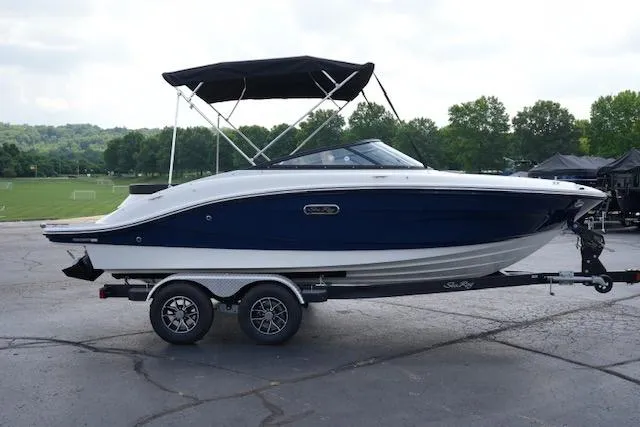 Slide: The Image of 2025 Sea Ray SPX 190 boat on trailer, parked outdoors with lush green background. - 3