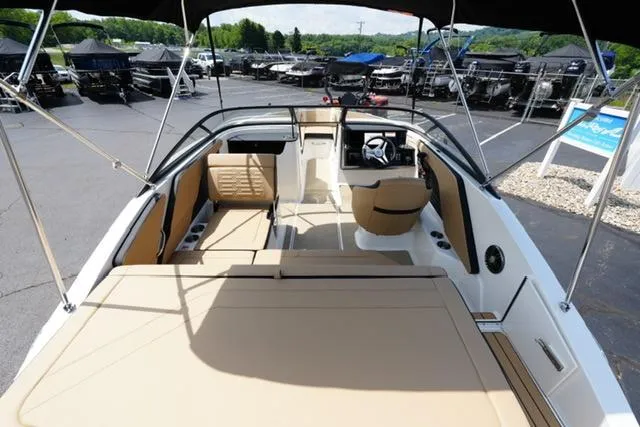 Slide: The Image of 2025 Sea Ray SPX 190 boat interior with tan seating and modern dashboard. - 7